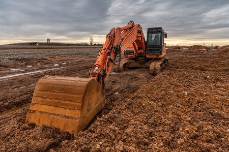 Excavator doing work on a wet and muddy winter day