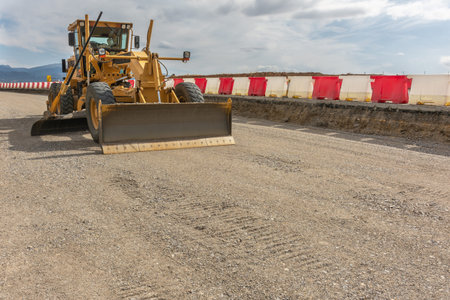 Paving the ground at road construction works with a bulldozerの写真素材