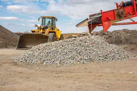 Excavator at a construction site in the extraction of stone and rockの写真素材