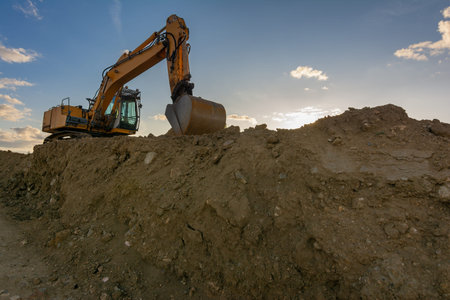 Excavator moving dirt and sand at a construction site
