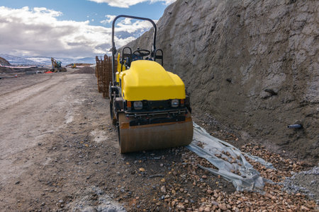 A mini steamroller at a road construction site