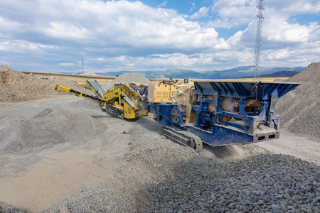 Heavy and mobile machinery in a quarry to transform stone into construction material