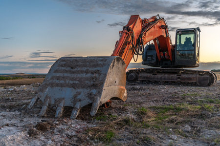 Excavator moving dirt and sand at a construction site
