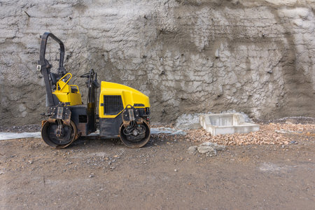 A mini steamroller at a road construction site
