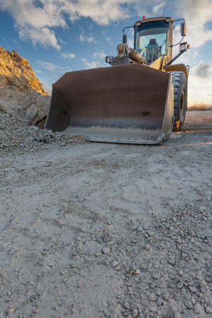 Heavy and mobile machinery in a quarry to transform stone into construction material
