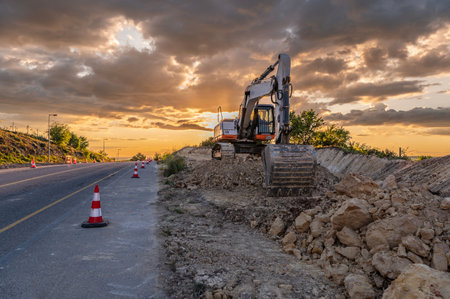 Works of extension of a road with excavator