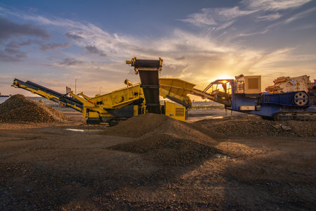 Heavy and mobile machinery in a quarry to transform stone into construction materialの写真素材