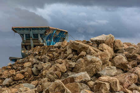 Heavy and mobile machinery in a quarry to transform stone into construction material