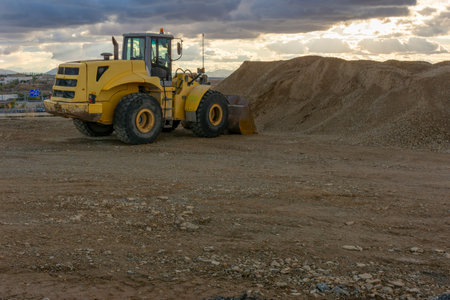 Excavator at the end of a working day at a construction site in a beautiful evening