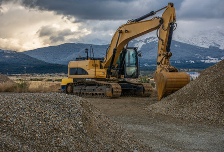 Excavator at the end of a working day at a construction site in a beautiful eveningの写真素材