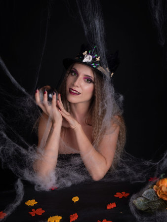 woman looking at camera between spider websの写真素材