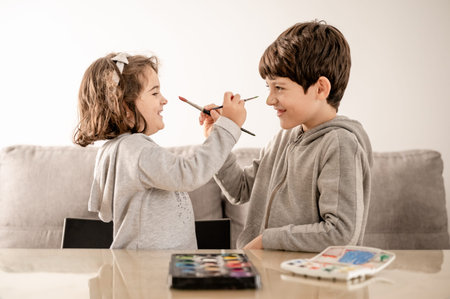 Brothers playing face painting with watercolorの写真素材