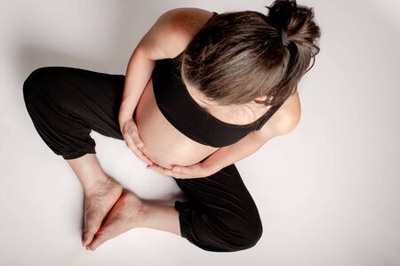 Cenital view of pregnant woman in white backgroundの写真素材