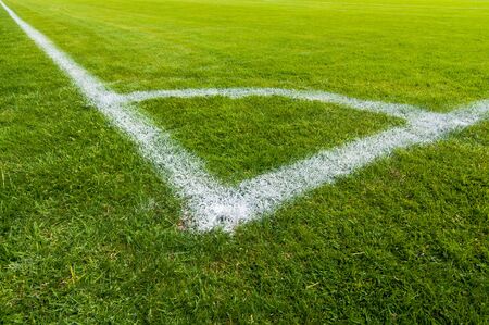 White lines from a football field. Perfect green grass. Dividing line for gameの写真素材