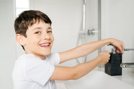 boy washing his hands after playing to fight the coronavirusの写真素材