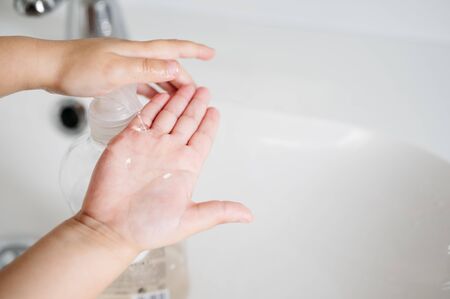 boy washing his hands after playing to fight the coronavirus. Close up of handsの写真素材