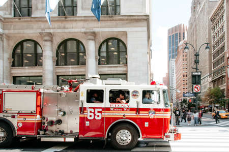 new york firefighters in a truck ready to heed a noticeのeditorial素材