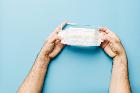 view of a doctors hands properly fitting gloves and mask with everything needed to fight the...