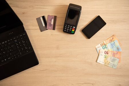 Polish currency money and credit card with payment terminal in background, paying using credit card or cash, finance and banking conceptの写真素材