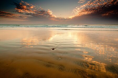 A sunset over a body of waterの写真素材