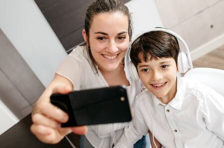 Mature mother with his children taking a selfieの写真素材