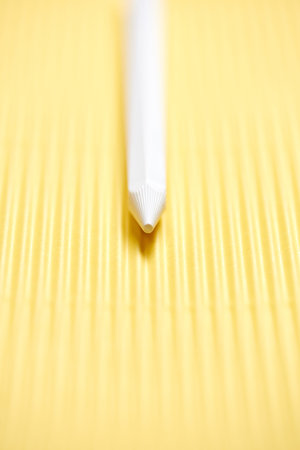 multi-colored pencils on a yellow and brown cardboard