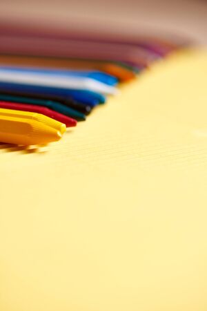multi-colored pencils on a yellow and brown cardboardの写真素材