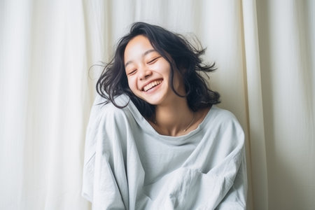 Beautiful young asian woman smile and relax in the morningの素材