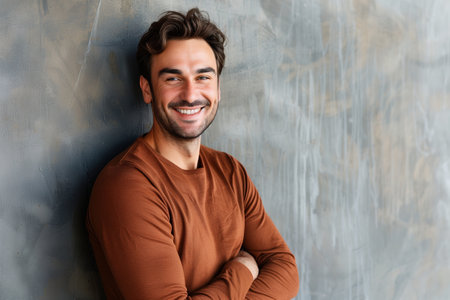 Young man with beard posing in a brown sweaterの素材