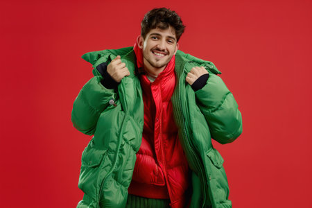 A man in a green jacket and red coat is smilingの素材