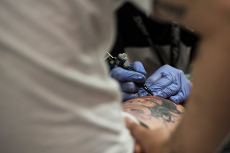 A tattooist working on a skin skinのeditorial素材