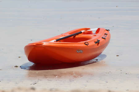 Kayak laying on the beachの写真素材