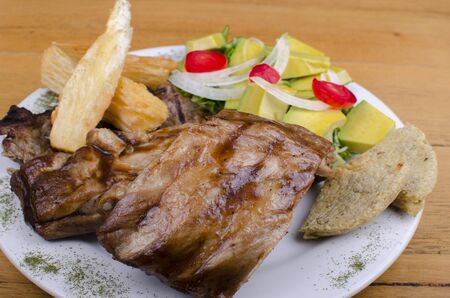 BBQ rib, with arepa, cassava and onionの写真素材