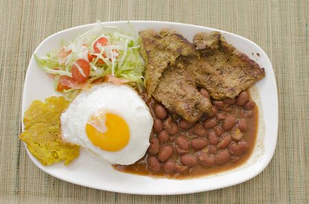 Colombian typical food, meat, rice, egg, salad and beansの写真素材