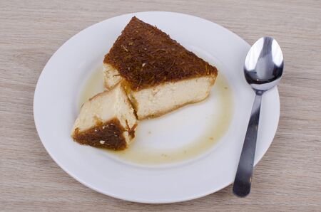 Caramel custard and a lot of sweet sauce on wooden backgroundの写真素材