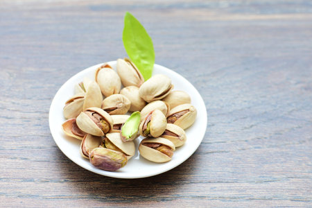 Whole, dried, open, whole, shelled and chopped dried pistachios displayed in containers