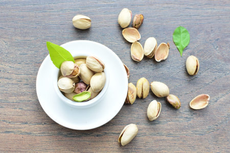 Whole, dried, open, whole, shelled and chopped dried pistachios displayed in containers