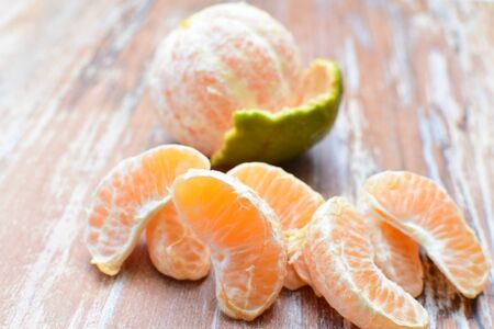 Whole tangerine fruit, chopped, with peel on textured backgroundsの写真素材