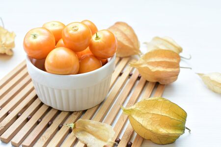 fresh whole gooseberries, shelled and sliced, displayed in containersの写真素材
