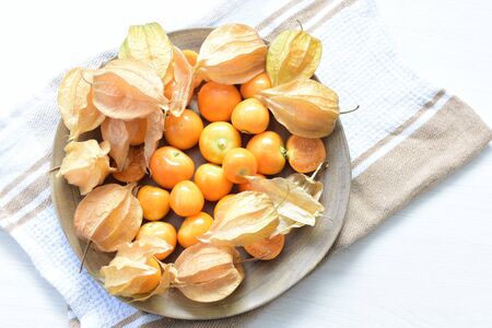 fresh whole gooseberries, shelled and sliced, displayed in containersの写真素材