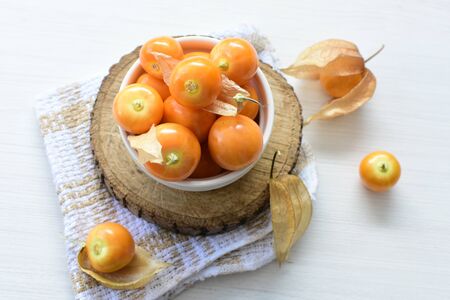 fresh whole gooseberries, shelled and sliced, displayed in containersの写真素材