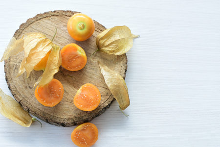fresh whole gooseberries, shelled and sliced, displayed in containers