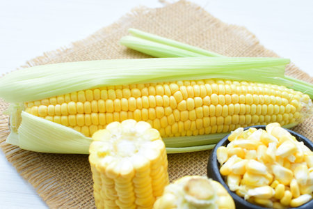 yellow sweet corn (cob) and green husk, chopped and shelled corn