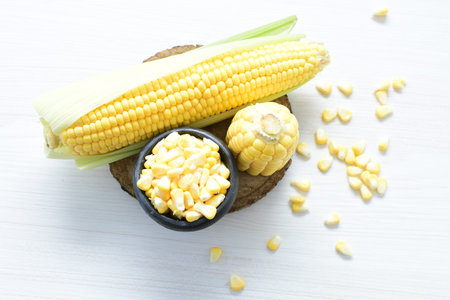 yellow sweet corn (cob) and green husk, chopped and shelled corn