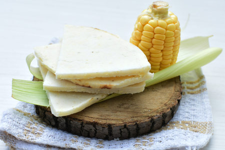 yellow sweet corn (cob) and green husk, chopped and shelled corn
