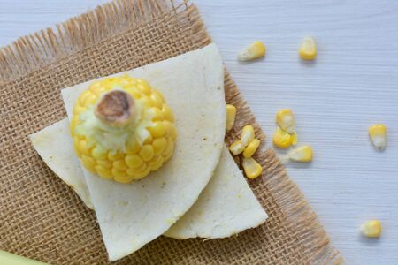 yellow sweet corn (cob) and green husk, chopped and shelled cornの写真素材