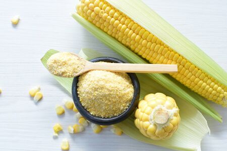 yellow sweet corn (cob) and green husk, chopped and shelled cornの写真素材