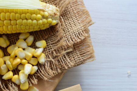yellow sweet corn (cob) and green husk, chopped and shelled cornの写真素材