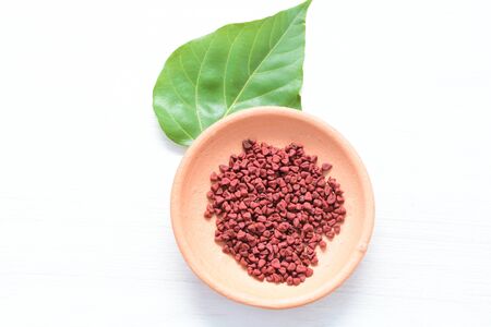Achiote, annatto, bixin, urucÃº or onoto is a natural red pigment for colorants and cooking displayed in seed containersの写真素材