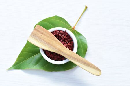 Achiote, annatto, bixin, urucÃº or onoto is a natural red pigment for colorants and cooking displayed in seed containersの写真素材